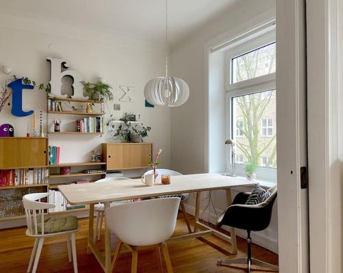 a white dining room with a table and chairs at Apartment_Lucas in Hamburg