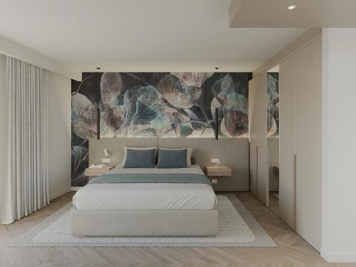 a bedroom with a bed with a painting on the wall at Résidence Apa Nera in Calenzana