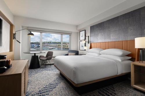 a hotel room with a bed and a desk at Sheraton Erie Bayfront Hotel in Erie