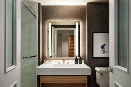a bathroom with a sink and a mirror at Sheraton Erie Bayfront Hotel in Erie
