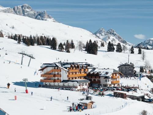 a ski lodge on a snow covered mountain at Hotel San Marco in Passo San Pellegrino