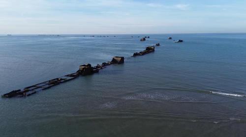 a group of rocks in the middle of the water at Gold Beach Hotel & RESIDENCE in Asnelles