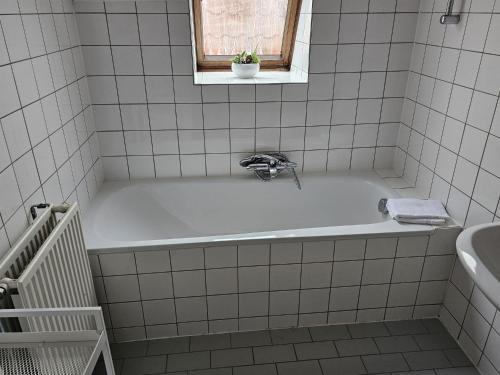 a bath tub with a faucet in a bathroom at City Centre Suite in Hoorn
