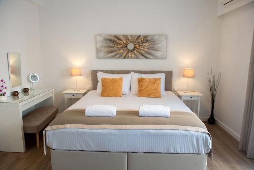 a bedroom with a large bed with orange pillows at Dante Apartment in Athens