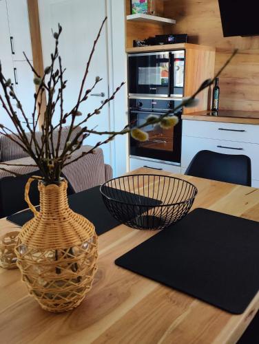 a wooden table with a vase on top of it at Ostsee-Fynn in Graal-Müritz