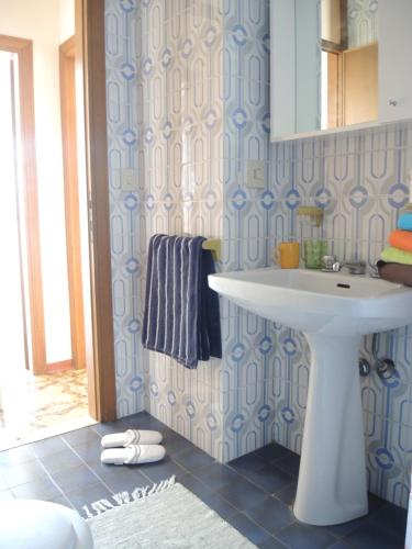 a bathroom with a white sink and a mirror at CAVALLINO in Bibione