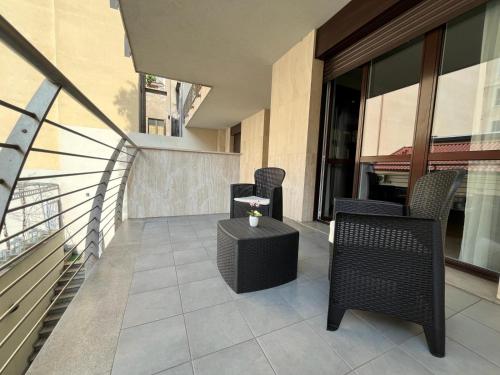 a balcony with chairs and a table on a building at PREMUDA20 Milan Elegant Apartment in Milan