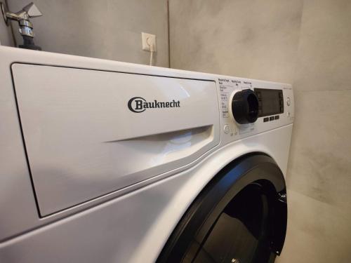 a white washing machine sitting in a room at Ostsee-Fynn in Graal-Müritz