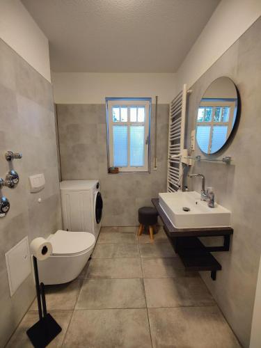 a bathroom with a toilet and a sink at Ostsee-Fynn in Graal-Müritz