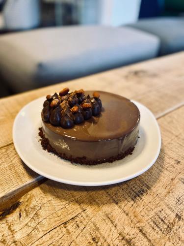 a chocolate cake on a plate on a table at Hôtel 16 | 150 Montagne & Spa Nuxe in Vars