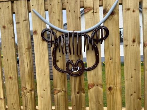 a pair of hoses hanging on a wooden fence at Rowan Bank Retreat in Fort Augustus