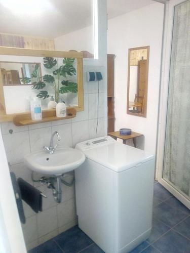 a white bathroom with a sink and a toilet at Brachelen in Hückelhoven
