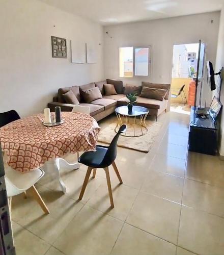 a living room with a table and a couch at Samira in Rufisque