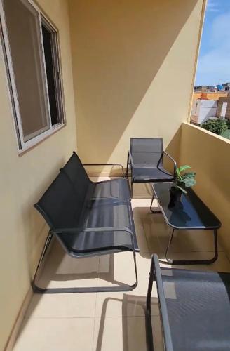 two chairs and a table on a balcony at Samira in Rufisque