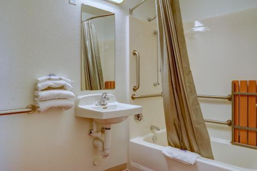 a bathroom with a sink and a shower and a mirror at Motel 6-Eugene, OR - South Springfield in Eugene