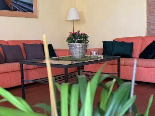 a living room with a couch and a table with a plant at Suite Gabri, Stiozzi Ridolfi in Certaldo