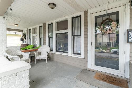 a porch with chairs and a table and windows at Cozy Home Near Fountain Square & 5 Min Lucas Oil in Indianapolis
