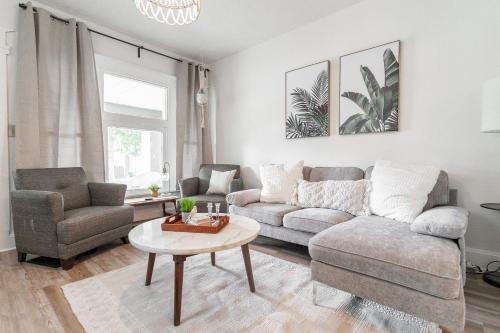 a living room with a couch and a table at Cozy Home Near Fountain Square & 5 Min Lucas Oil in Indianapolis
