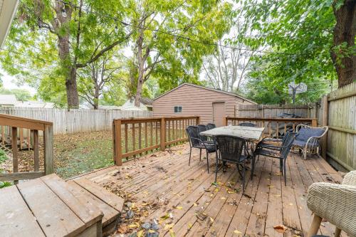 a wooden deck with a table and chairs on it at Cozy Home Near Fountain Square & 5 Min Lucas Oil in Indianapolis