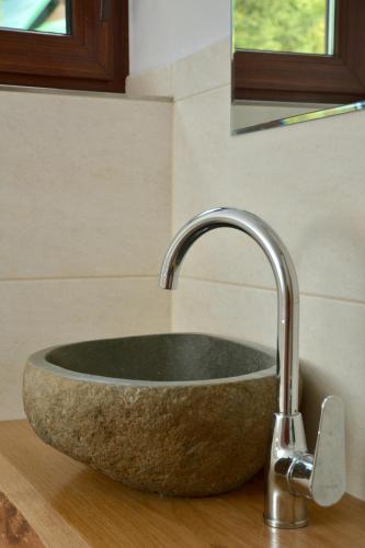 a sink in a bathroom with a stone sink at Chata na Trávniku 302 in Horná Turecká