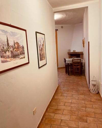 a hallway with paintings on the walls and a dining room at Casa Vacanze Nonna Vittoria in Spoleto