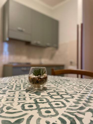 a glass bowl with a plant in it sitting on a table at Casa Vacanze Nonna Vittoria in Spoleto