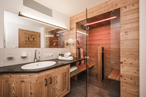 a bathroom with a sink and a shower at Enzianhof - Nature Apartments in San Giovanni in Val Aurina