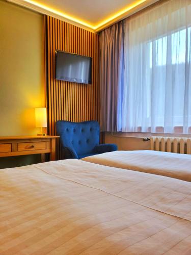 Letto o letti in una camera di Pension Am Nationalpark