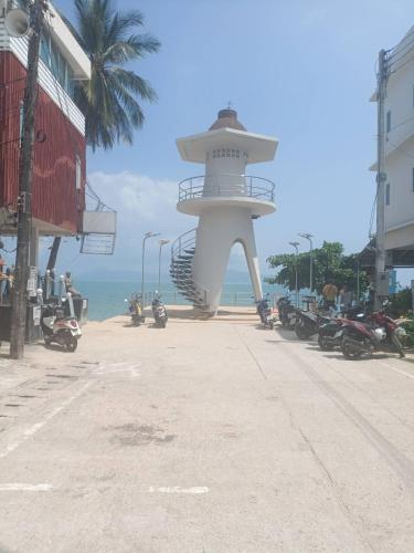 a sculpture on the beach near the ocean at Wasin House One Bedroom - Maenum in Mae Nam