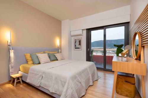 a bedroom with a large bed and a large window at Apollo Tower Athens Center 360oView Luxury Apt in Athens