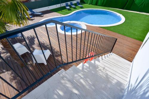 a deck with a swimming pool and a fence at O Paço - exclusive accommodation in Tomar