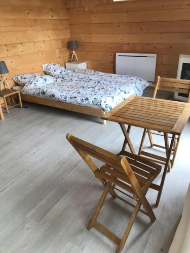une chambre avec un lit, une table et des chaises dans l'établissement Perchoir de ceuse, à Sigoyer