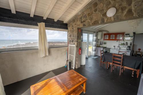 a living room with a table and a view of the ocean at Casa Atlantida - Sea front in Faja Grande
