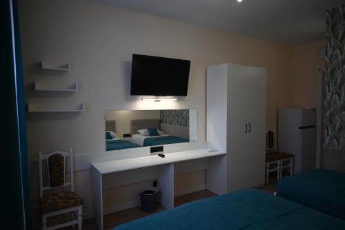 una camera con letto e scrivania con specchio di Hotel Korona a Verbovatovka