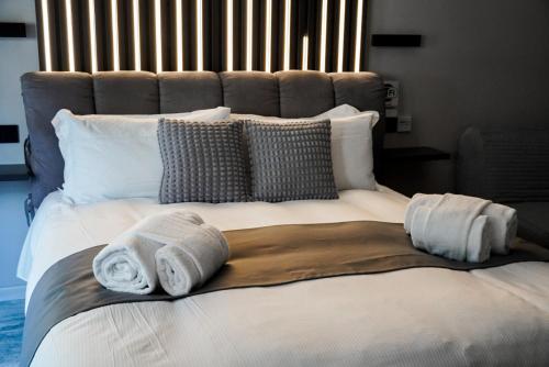 a large bed with two towels on top of it at Hey Suite Luxury GuestHouse Roma-Trastevere in Rome