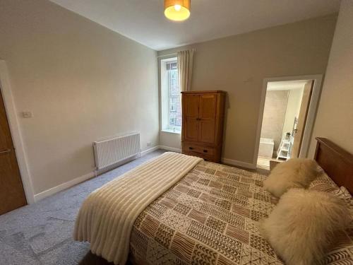 a bedroom with a large bed and a window at Apartment 381 in Jesmond