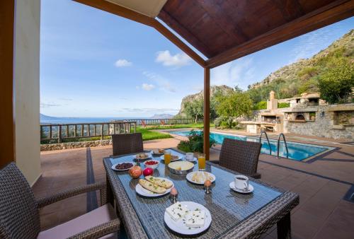 a table with food on it on the patio of a house at Malathiros Traditional Villas in Maláthiros