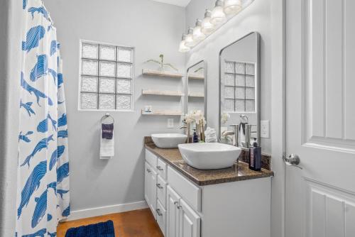a bathroom with two sinks and a mirror at Island Time in Port Aransas