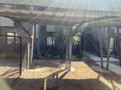 a building with awning in front of a building at Depto del Bosque, 4 personas, patio, cochera cubierta ,parrilla in Maipú
