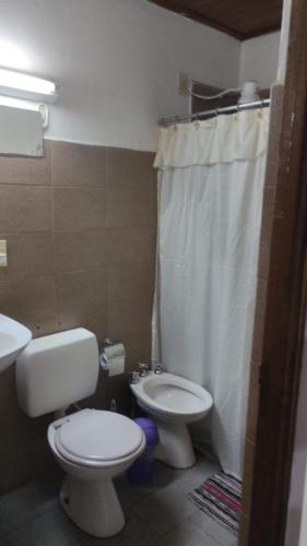 a bathroom with a toilet and a sink and a shower at Departamentos Alicia in Puerto Rico