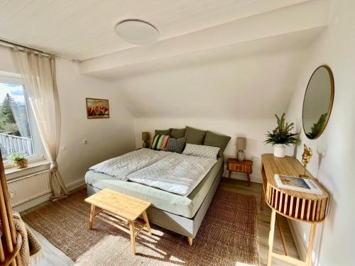 a bedroom with a bed and a table at Art-Apartment with Terrace in Monschau in Monschau