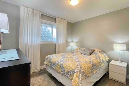 a bedroom with a bed and a desk and a window at White House Suite - Sleeps 4 in St. Catharines