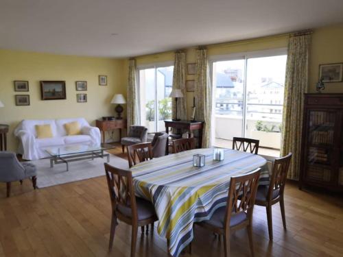 un salon avec une table, des chaises et un canapé dans l'établissement Superb duplex with stunning view of Eiffel Tower, à Boulogne-Billancourt