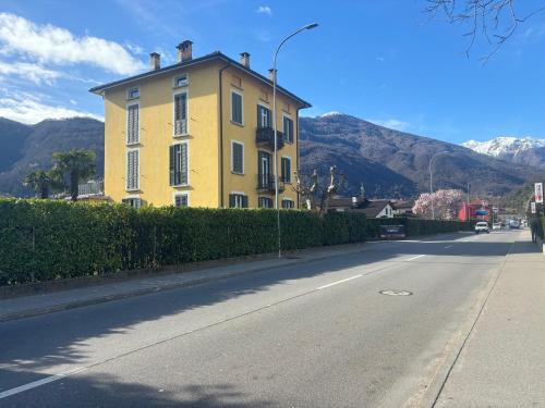 a yellow building on the side of a street at Small apartments in Lamone in Lamone