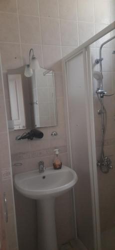 a bathroom with a sink and a mirror at La Casa de Oludeniz, Fethiye in Fethiye