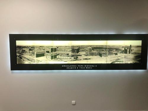 a black and white picture of a factory on a wall at Apartimento Hydral Fresco in Wrocław