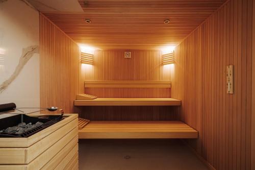 a sauna with wood paneling and lights in a room at Hotel Slatina in Rogaška Slatina