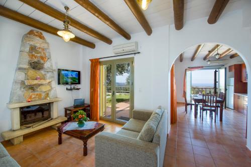 a living room with a couch and a fireplace at Malathiros Traditional Villas in Maláthiros