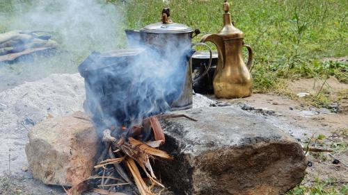 a pot sitting on top of a camp fire at Dana luxury huts in Dana