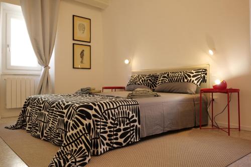 a bedroom with a bed with zebra print sheets at Maison62 in San Severino Marche